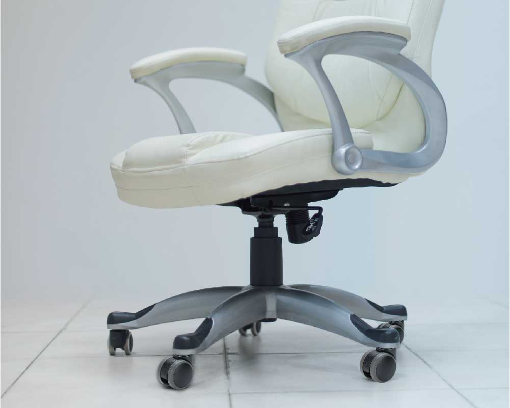 White office chair with caster wheels on a tiled floor.