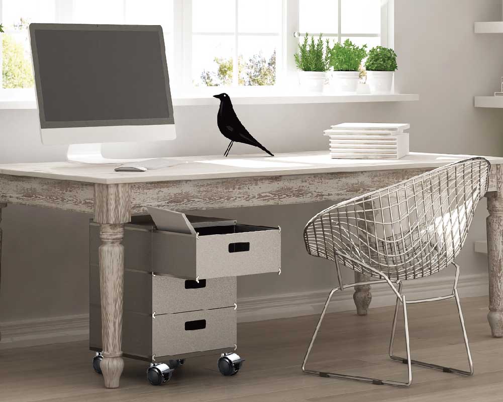 Home office setup with vintage desk and mobile drawer unit on casters