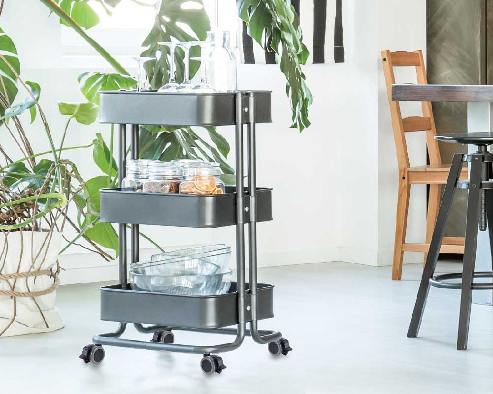 Three-tier rolling cart with storage in a cozy room setting